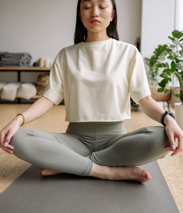 Person in a meditative pose, feeling calm and focused.